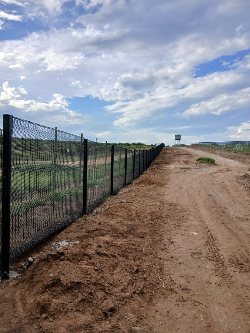 Long run of black Clearview fencing beside the solar plant, Hartenbos