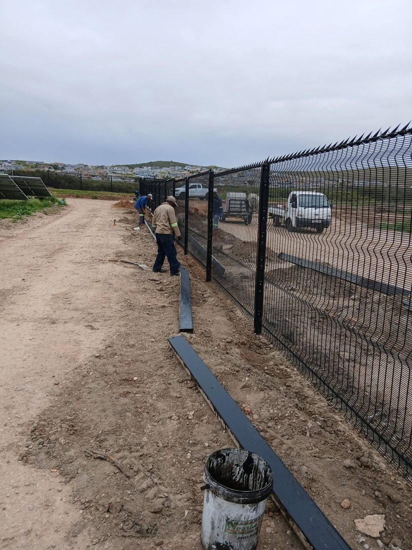 Bay Barrier team installing the underdig barrier along the Clearview fence line, Hartenbos