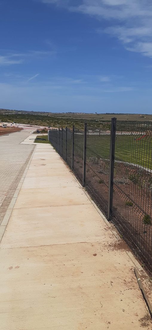 Clearview fence along the concrete walkway beside the school grounds
